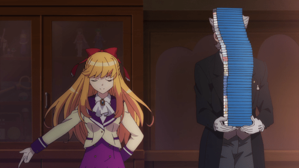 A blonde girl in a school uniform stands with her eyes closed and one hand stretched out to the side. Beside, her someone in a black suit and gloves stands, their face and most of their torso hidden by a tall stack of what appear to be blu-ray cases.
