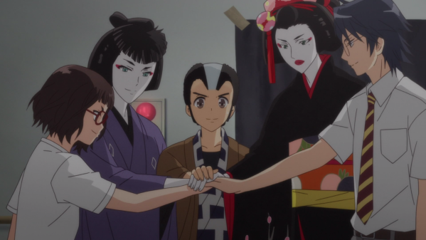 A group of high schoolers stand in a circle, their hands atop one another's in the center. From left to right: A girl in a school uniform and glasses; a girl in masculine traditional Japanese kabuki clothes; a boy wearing a wig and traditional clothes; a tall person wearing a kimono and traditional feminine kabuki makeup; and another boy wearing a school uniform