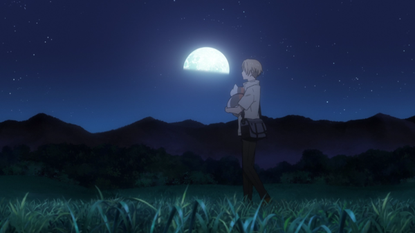 A teenage boy in a school uniform walks along a moonlit path in a grassy field, holding a chubby cat in his arms.