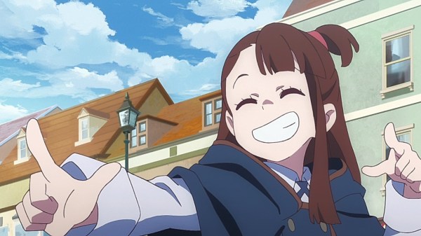 A teen girl (Akko) grins and points at someone off-screen.