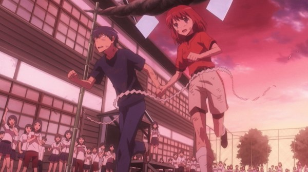Ryu and Minori cross a finish line at sunset, holding hands